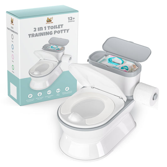 A 2-in-1 toilet training potty shown with its packaging box. The potty is white with gray accents, featuring an open lid that reveals a storage compartment with diapers, a toilet seat cover, and a roll of toilet paper on the side.